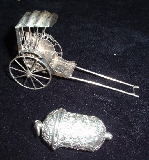 Appraisal: A miniature Eastern white metal rickshaw together with a thimble