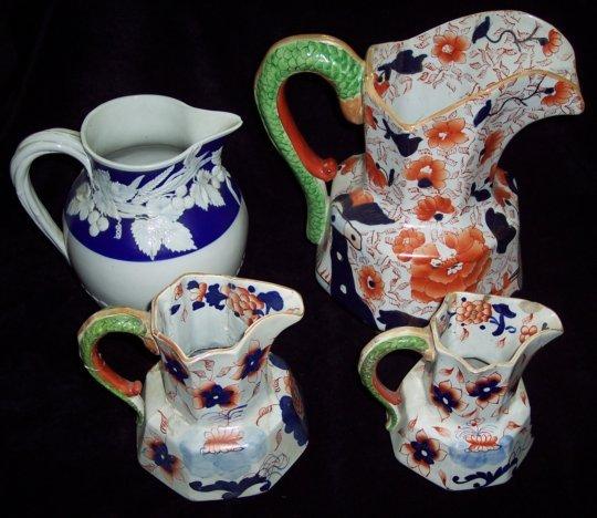 Appraisal: A large Ironstone China pitcher with serpent handle and decorated