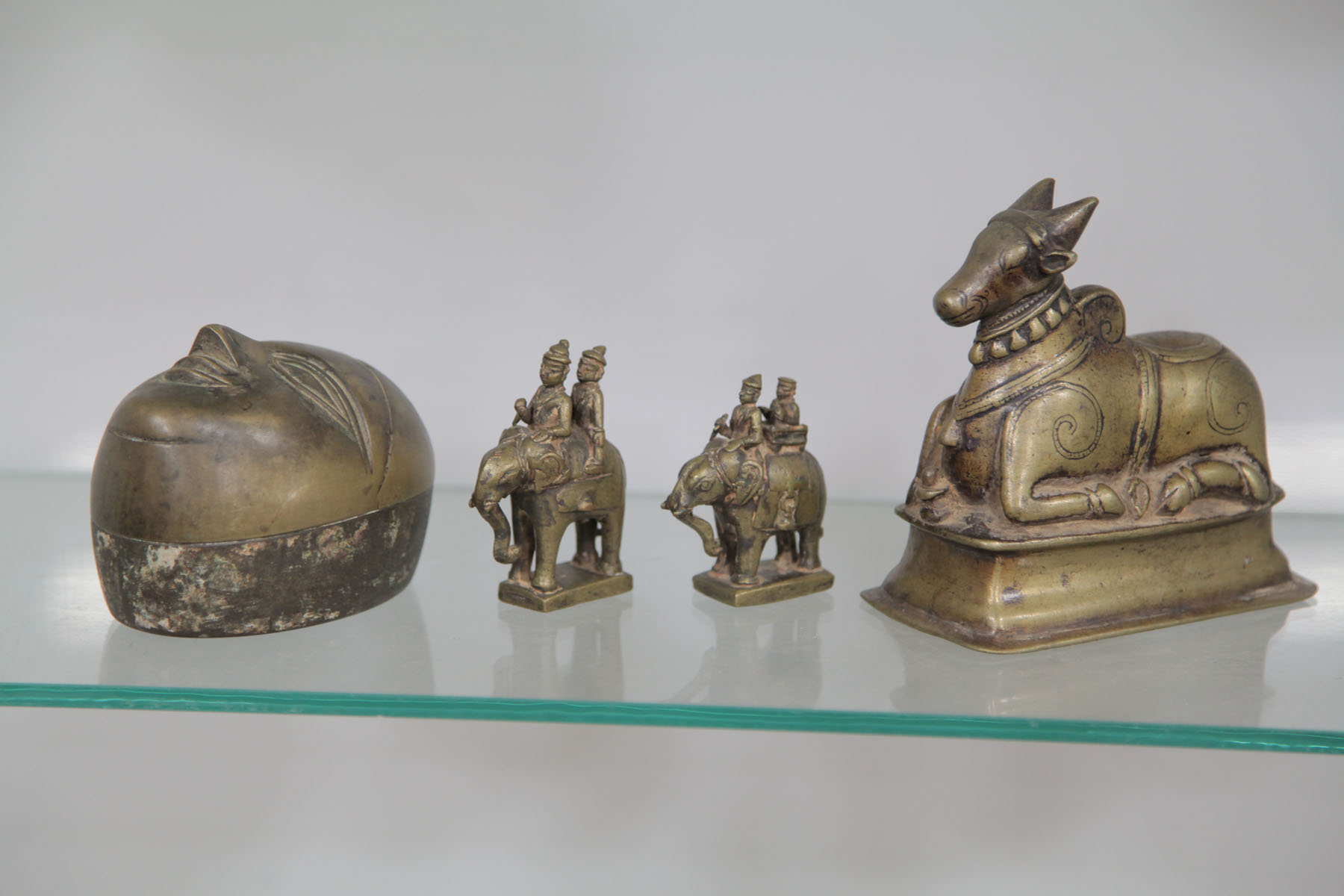 Appraisal: FOUR BRONZE ITEMS Bronze sculpture of Nandi resting on a