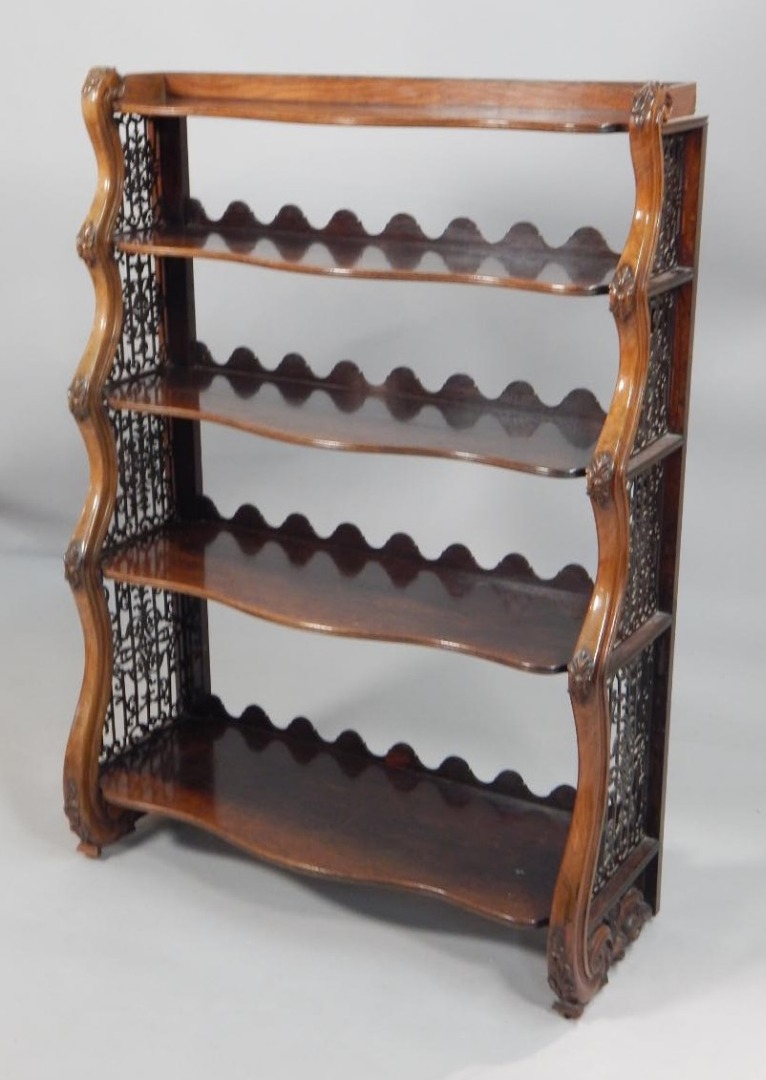 Appraisal: An early Victorian waterfall type bookcase with shaped shelves and