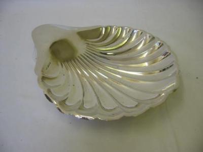 Appraisal: A FRUIT DISH modelled as a fluted shell with lug