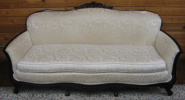 Appraisal: CLASSIC REVIVAL SOFA American c 's the carved dark wood