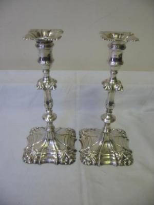 Appraisal: A PAIR OF GEORGE III CAST CANDLESTICKS with squared nozzle