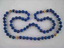 Appraisal: A lapis lazuli bead necklace with untested yellow metal spacers