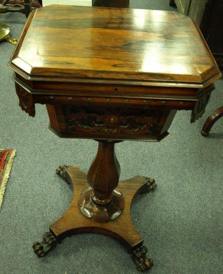 Appraisal: A Victorian rosewood work table the canted top disclosing a