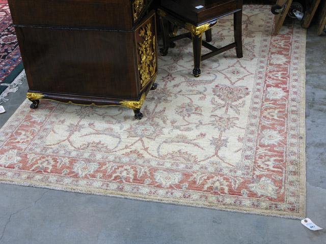 Appraisal: HAND KNOTTED ORIENTAL CARPET Pakistani Persian overall floral decorated khaki