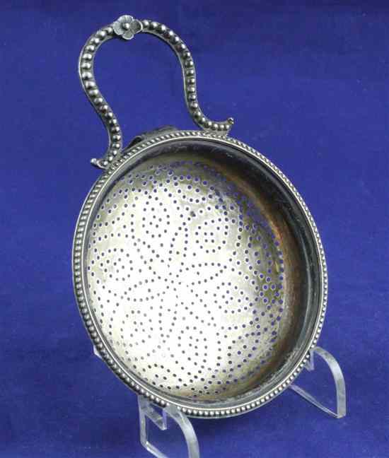 Appraisal: A George III silver lemon strainer with pierced foliate bowl