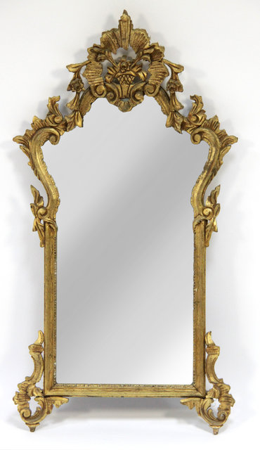 Appraisal: A gilt wall mirror with basket of flowers surmount the