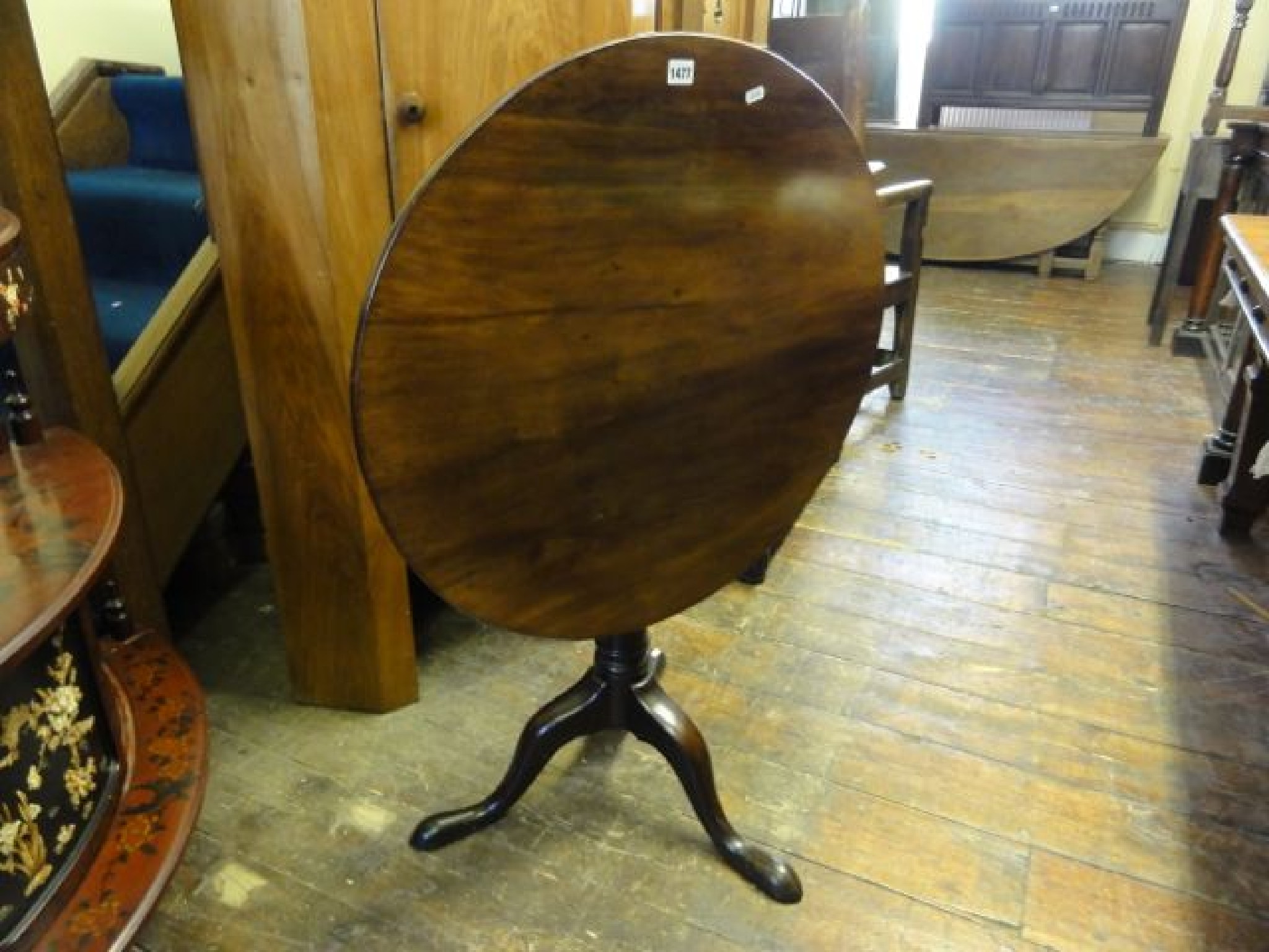 Appraisal: A Georgian mahogany snap top table raised on a gun