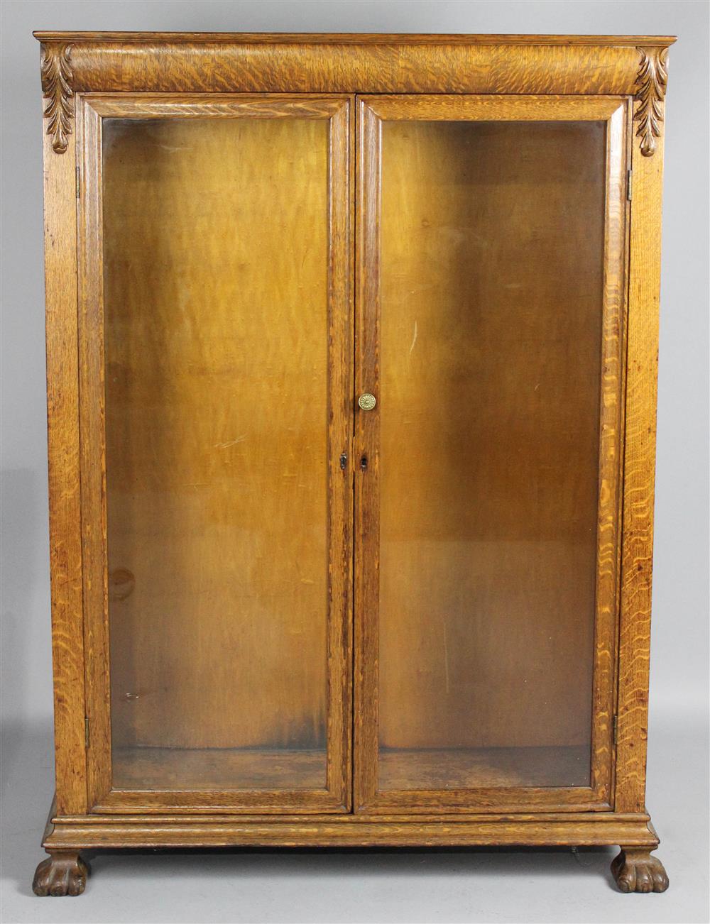 Appraisal: OAK DISPLAY CABINET th Century with cushion-molded frieze carved with