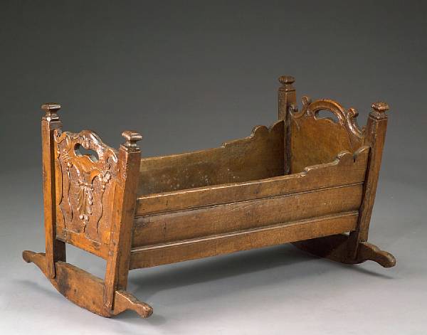 Appraisal: An Italian walnut cradle Lombardy th century The traditional form