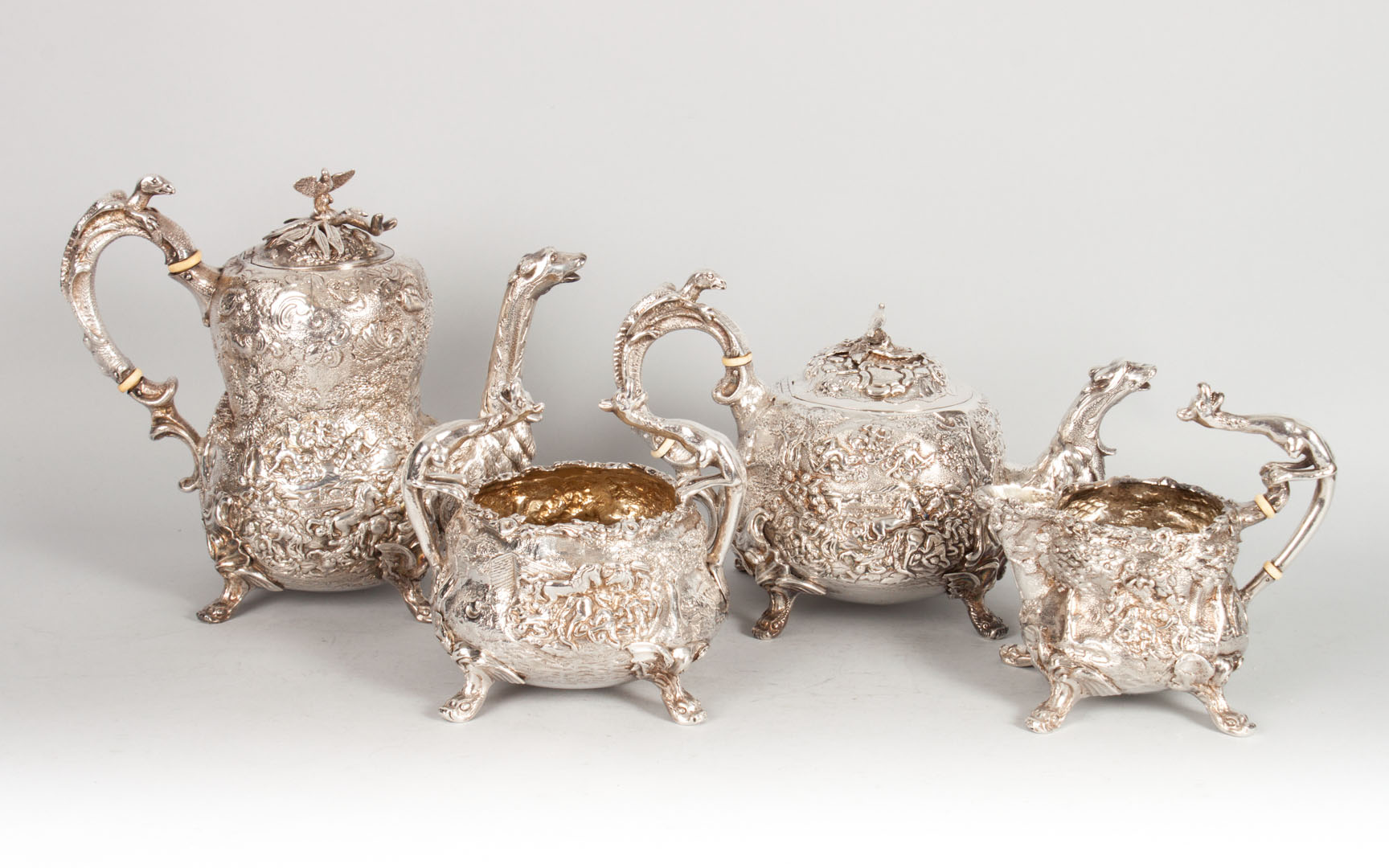 Appraisal: English Britannia silver coffee tea service with exceptionally ornate repousse