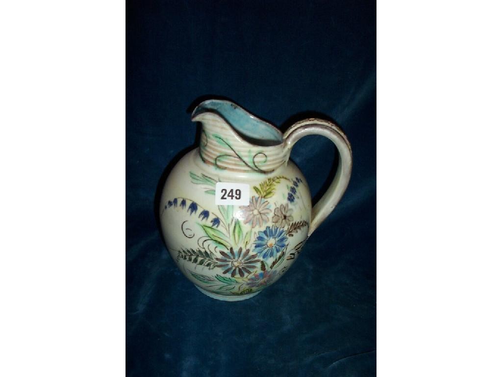 Appraisal: A pottery jug with painted floral sprays and moulded decoration