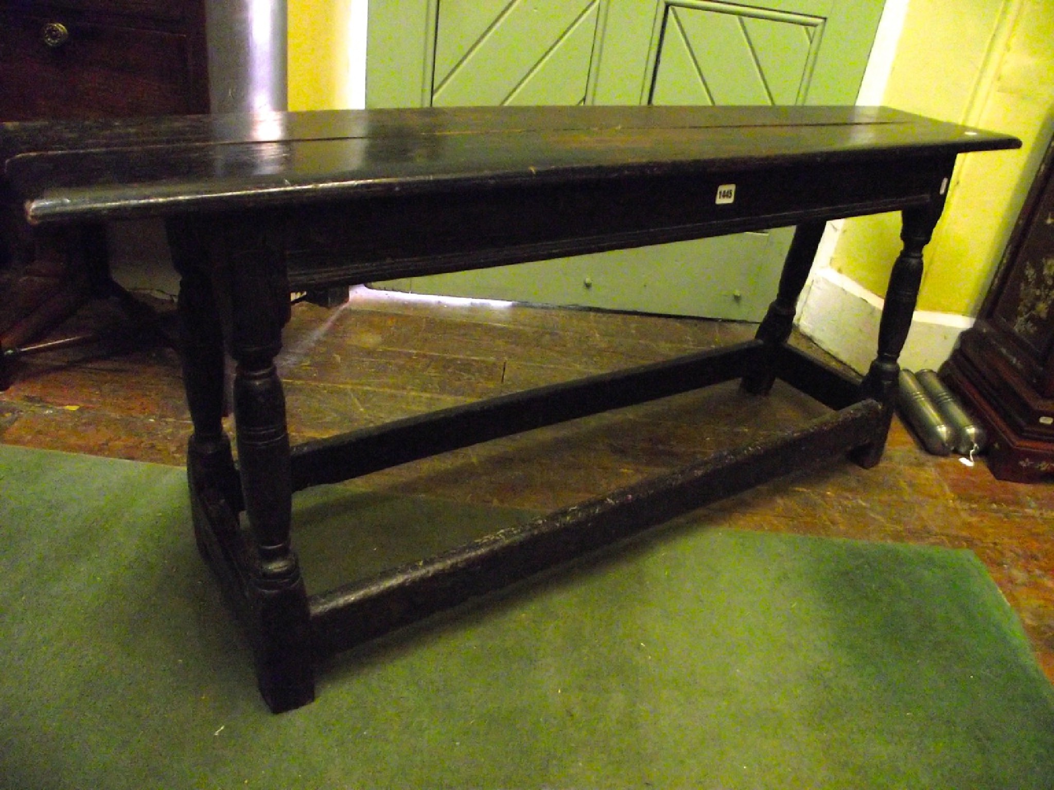 Appraisal: An old English oak bench with plank top raised on