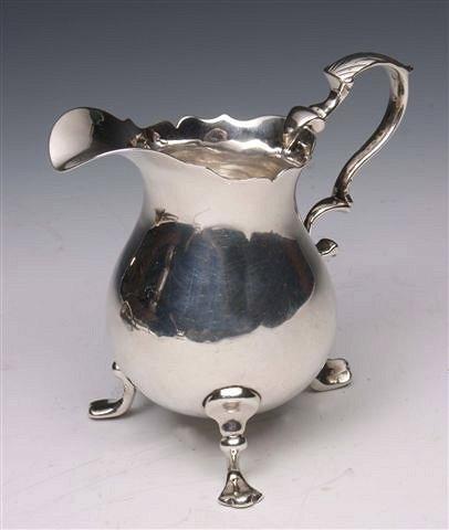 Appraisal: A GEORGE II SILVER CREAM JUG with wavy edge double