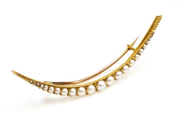 Appraisal: A gold and half pearl set brooch designed as a