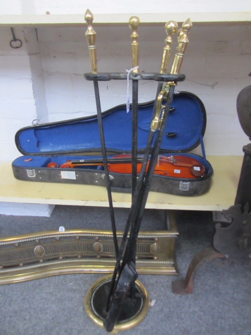 Appraisal: A set of ebonised metal fire tools and stand with