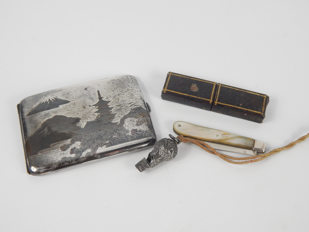 Appraisal: A Japanese tricolour silver cigarette case decorated with mountains and