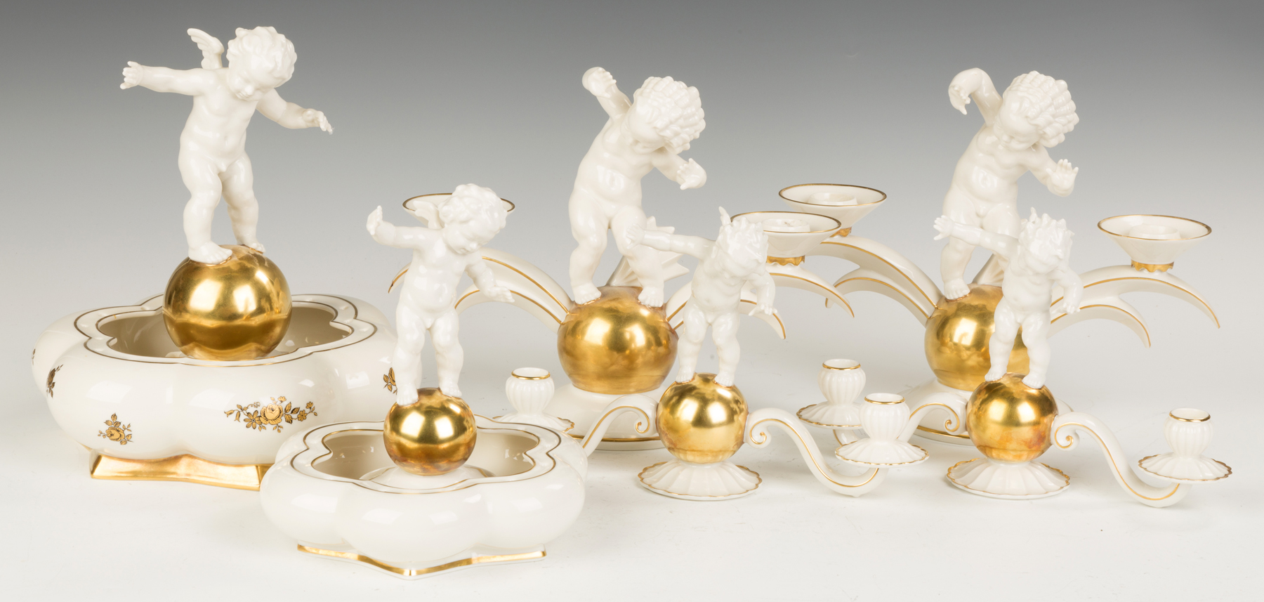 Appraisal: Porcelain Candleholders and Centerpieces With cherubs gold leaf Runsrobteilung Germany