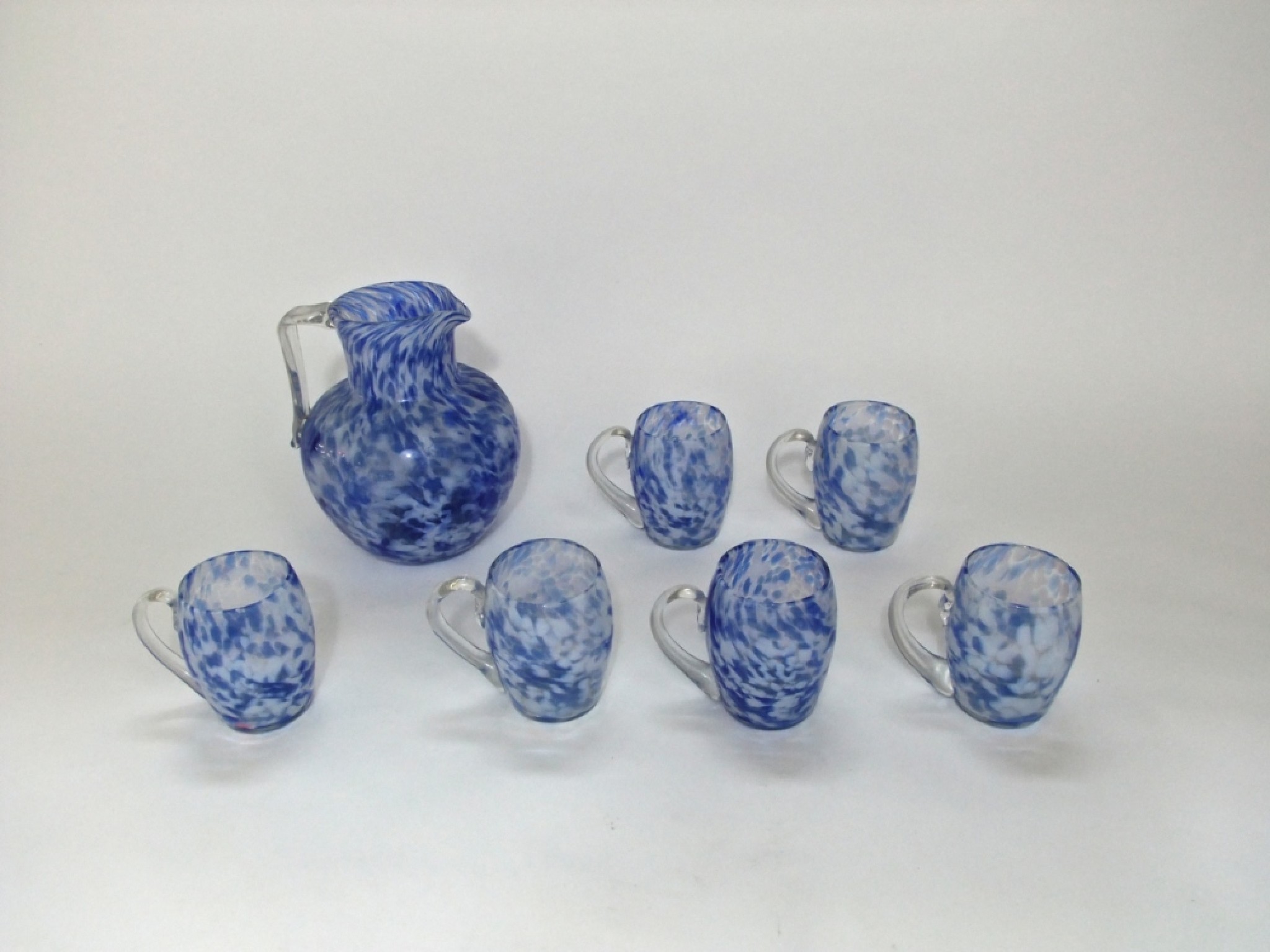 Appraisal: A hand blown Studio Glass jug with six associated cups