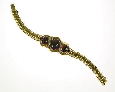 Appraisal: A garnet diamond and enamel set bracelet the large oval