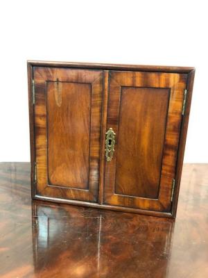 Appraisal: A George III mahogany cabinet enclosed by a pair of