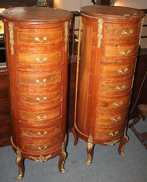 Appraisal: A PAIR OF CONTINENTAL CYLINDRICAL UPRIGHT CHESTS with gilt metal