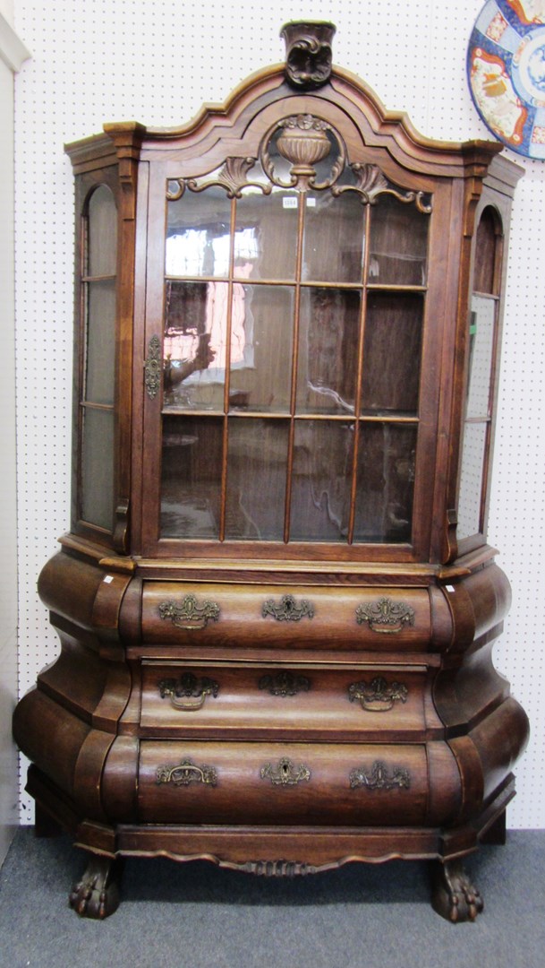 Appraisal: An th century Dutch oak display cabinet chest the bonnet