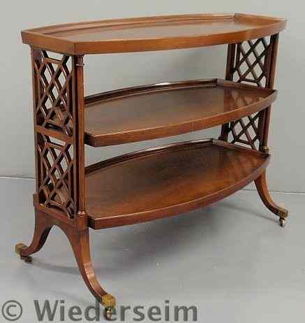 Appraisal: Regency style mahogany three-tier trolley table with brass cuffs and