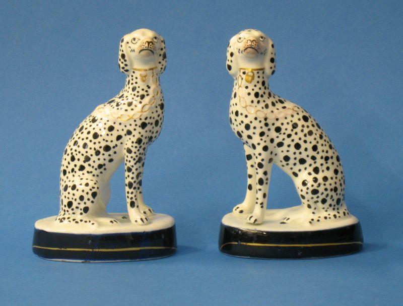 Appraisal: A PAIR OF STAFFORDSHIRE POTTERY DALMATIANS modelled seated black dot