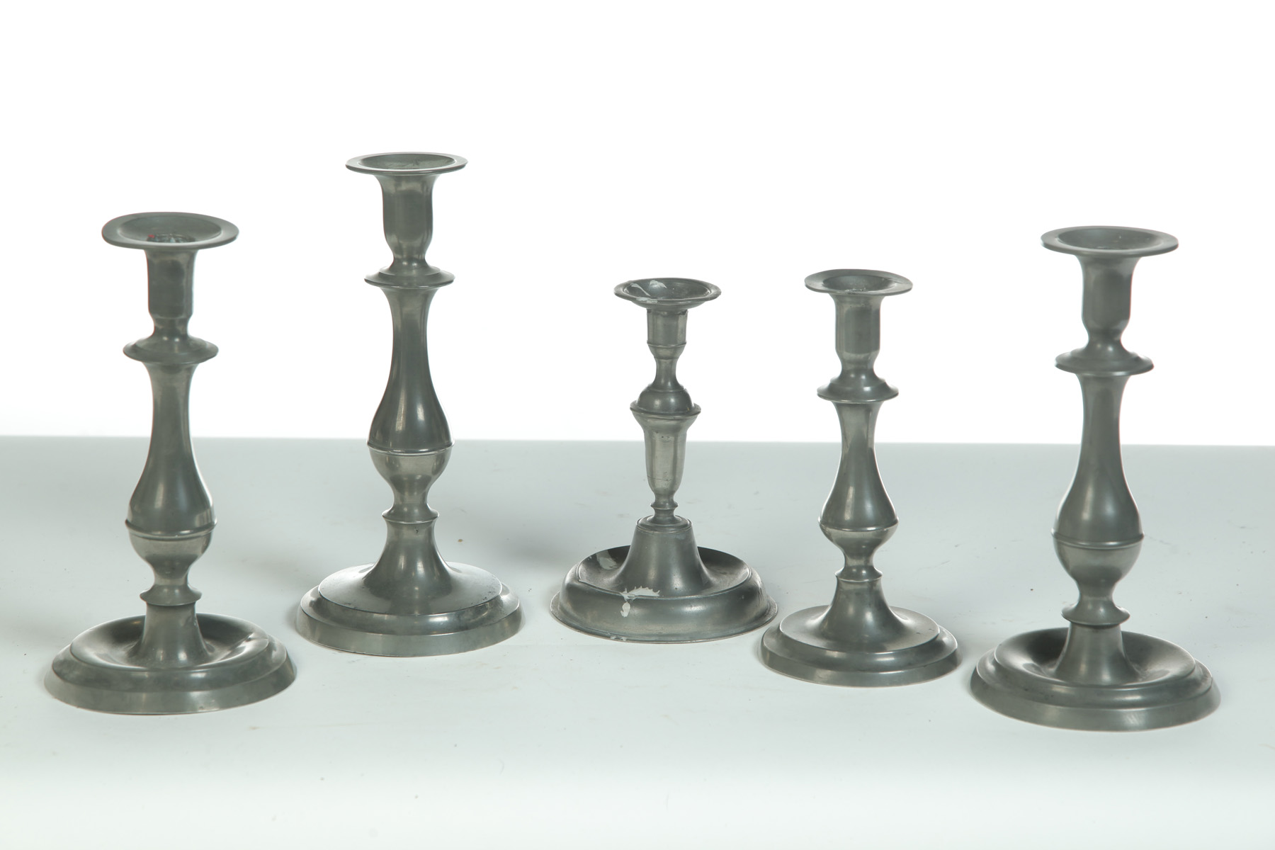 Appraisal: FIVE PEWTER CANDLESTICKS American first half- th century Single h