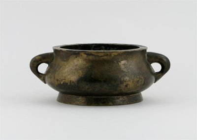 Appraisal: A Chinese bronze compressed circular incense burner with loop handles