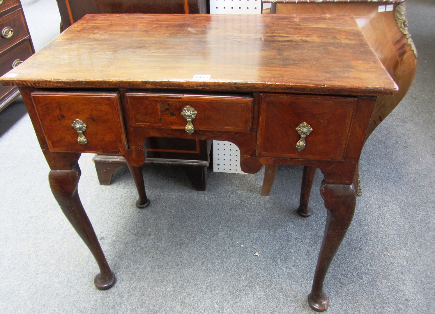 Appraisal: An th century oak and elm lowboy with three frieze