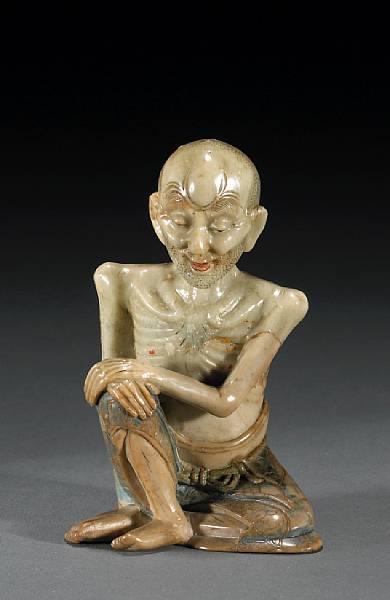 Appraisal: A tinted soapstone figure of a seated ascetic th Century