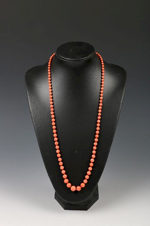 Appraisal: CORAL GRADUATED BEAD NECKLACE A strand of salmon-orange coral glazed