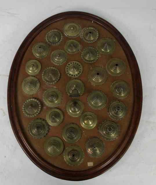 Appraisal: An oval frame mounted twenty-nine horse brass roses