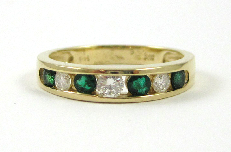 Appraisal: EMERALD DIAMOND AND FOURTEEN KARAT GOLD RING with four channel