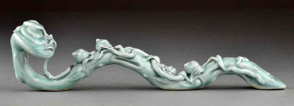 Appraisal: Chinese Qing Celedon Porcelain Ruyi ScepterFinely molded with peaches on