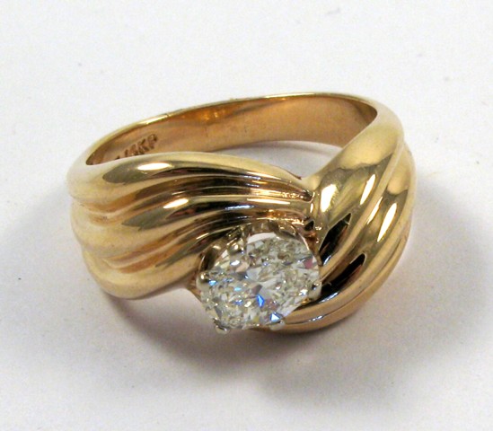 Appraisal: DIAMOND AND FOURTEEN GOLD RING centering an oval-cut diamond weighing