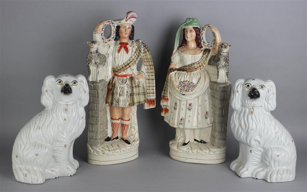 Appraisal: PAIR OF STAFFORDSHIRE HIGHLAND FIGURES AND A PAIR OF SPANIELS