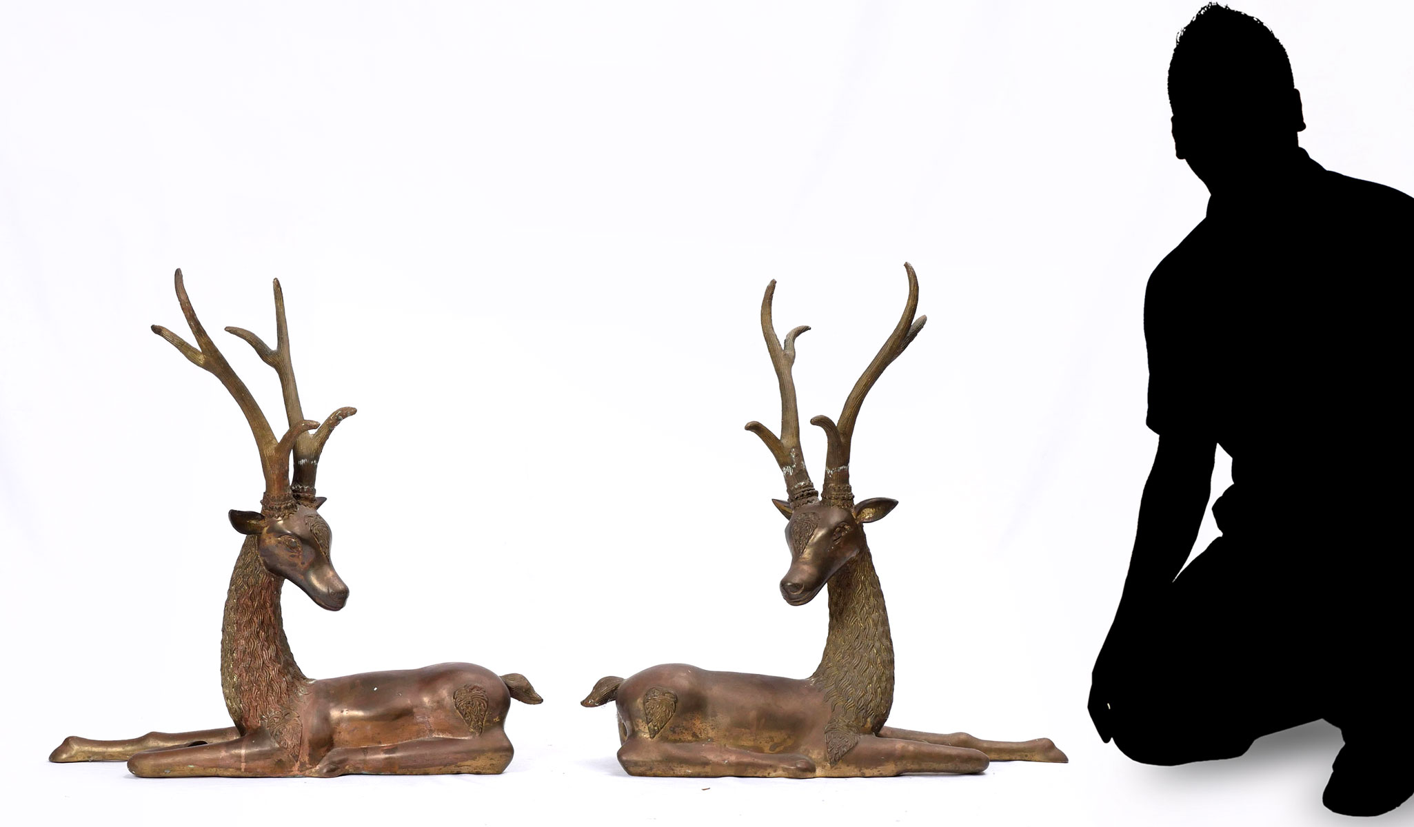 Appraisal: PAIR OF OPPOSING BRASS RECUMBENT STAG SCULPTURES opposing recumbent stags