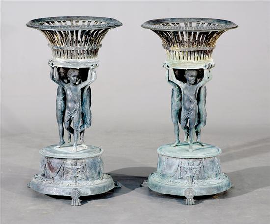 Appraisal: Pair cast-iron jardineres reticulated basin supported by putti on stepped