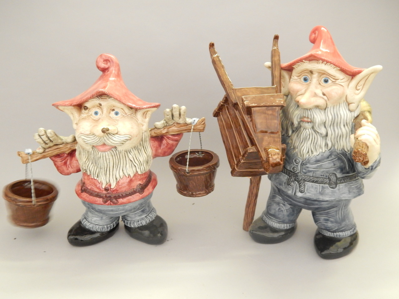 Appraisal: Two similar Studio Pottery garden gnomes one carrying water the