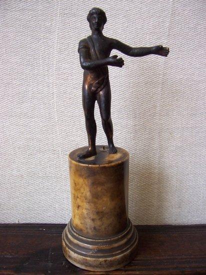 Appraisal: A bronze figure of a Classical youth on a turned