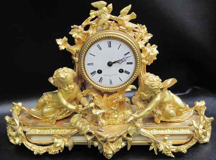 Appraisal: FRENCH GILT BRONZE FIGURAL CLOCK having seated winged cherubs feeding