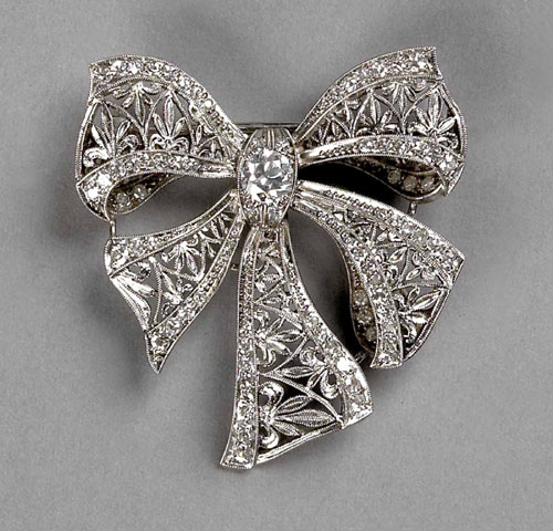 Appraisal: Platinum and diamond ribbon form brooch with diamonds approx ct