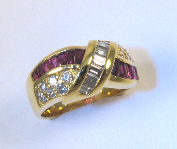 Appraisal: RUBY AND FOURTEEN KARAT GOLD RING set with tapered baguette