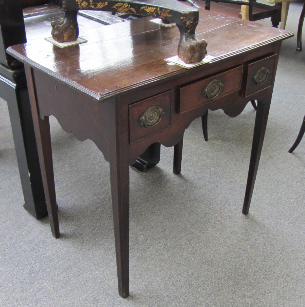 Appraisal: An th century oak low boy with three frieze drawers