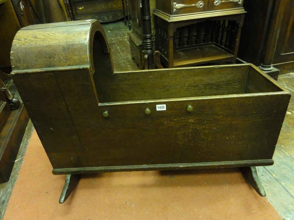 Appraisal: A Georgian oak cradle with arched canopy