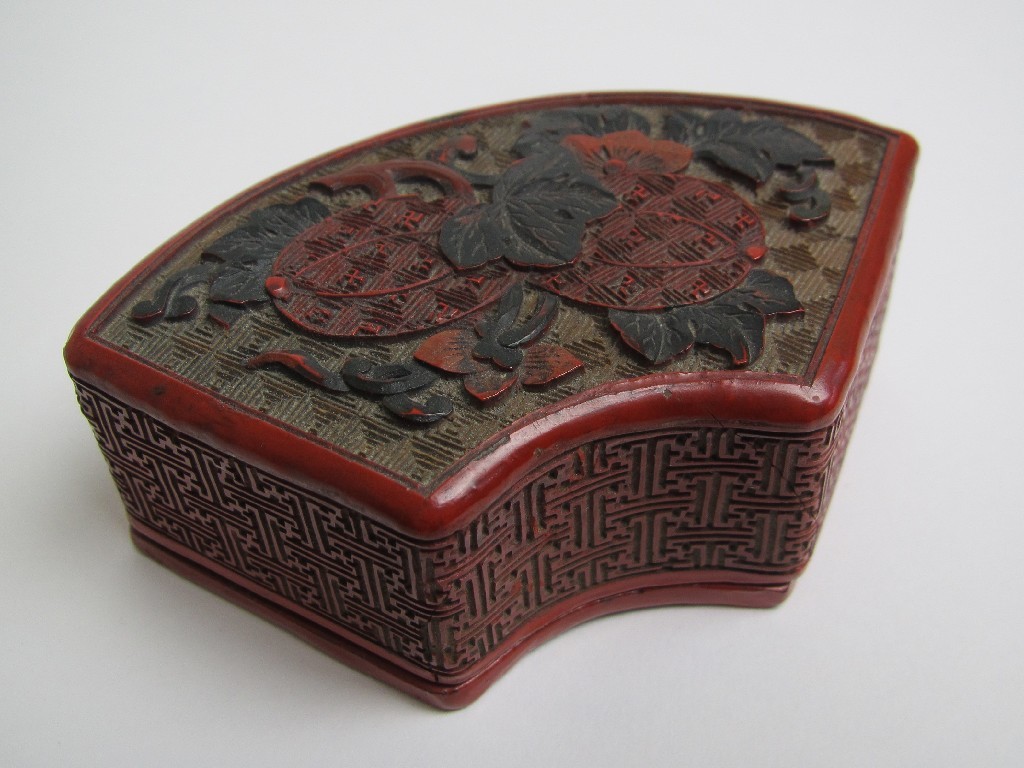 Appraisal: A Chinese fan shaped cinnabar lacquer box the cover with